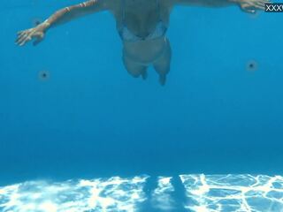 Vaatama tema ujuma alasti veeall sisse a bassein