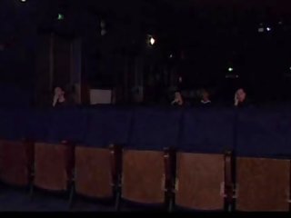 Busty milf gives head in a cinema hall